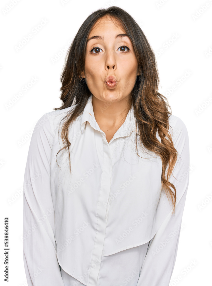 Young brunette woman wearing casual clothes making fish face with lips, crazy and comical gesture. funny expression. Young brunette woman wearing casual clothes making fish face with lips, crazy and comical gesture. funny expression.