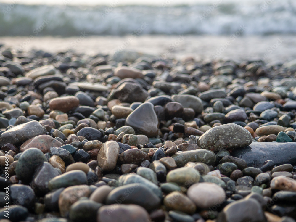 Pebbles on the seashore close-up. Rocky beach. Stones close-up with bokeh. Gray natural background. Autumn on the seashore Pebbles on the seashore close-up. Rocky beach. Stones close-up with bokeh. Gray natural background. Autumn on the seashore