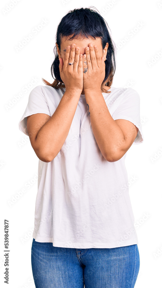 Young woman wearing casual clothes with sad expression covering face with hands while crying. depression concept. Young woman wearing casual clothes with sad expression covering face with hands while crying. depression concept.