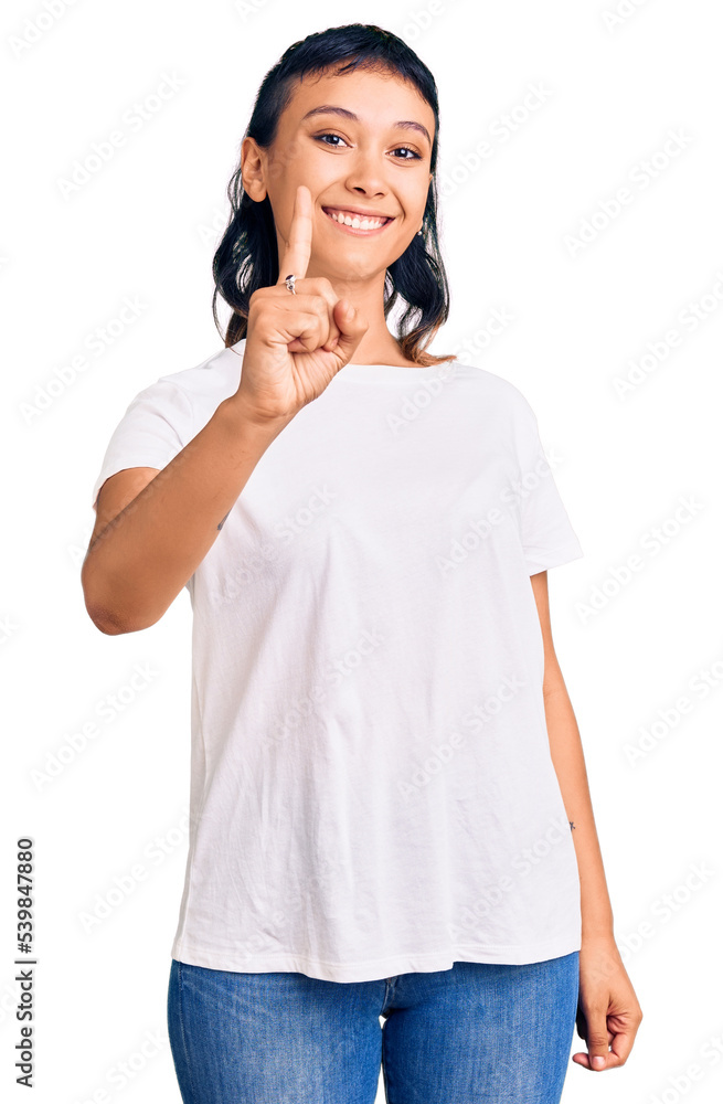 Young woman wearing casual clothes showing and pointing up with finger number one while smiling confident and happy. Young woman wearing casual clothes showing and pointing up with finger number one while smiling confident and happy.