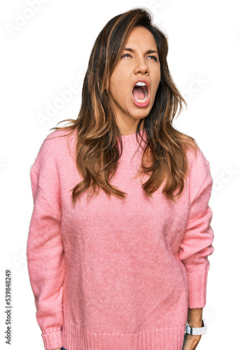 Young hispanic woman wearing casual clothes angry and mad screaming frustrated and furious, shouting with anger. rage and aggressive concept. © Krakenimages.com