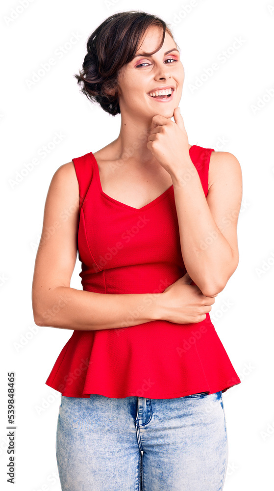 Fototapeta premium Beautiful young woman with short hair wearing casual style with sleeveless shirt looking confident at the camera smiling with crossed arms and hand raised on chin. thinking positive.