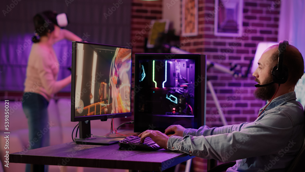 Man streaming multiplayer online first person shooter on pc while ...