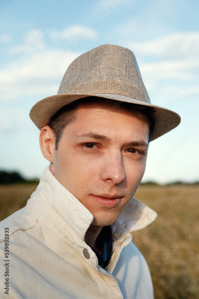 portrait of man in hat in field