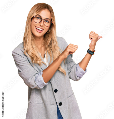Obraz na plátně Beautiful blonde young woman wearing business clothes pointing to the back behin