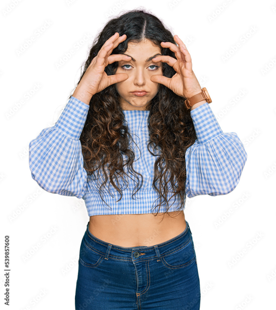 Young hispanic girl wearing casual clothes trying to open eyes with fingers, sleepy and tired for morning fatigue Young hispanic girl wearing casual clothes trying to open eyes with fingers, sleepy and tired for morning fatigue