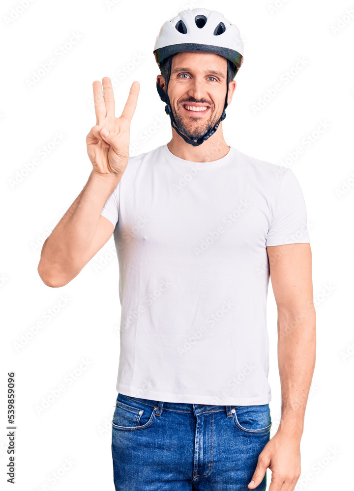Young handsome man wearing bike helmet showing and pointing up with fingers number three while smiling confident and happy. Young handsome man wearing bike helmet showing and pointing up with fingers number three while smiling confident and happy.