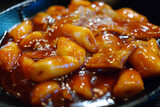 Tteokbokki is a popular Korean snack food. It's made from soft rice cake, fish cake and sweet red chili sauce