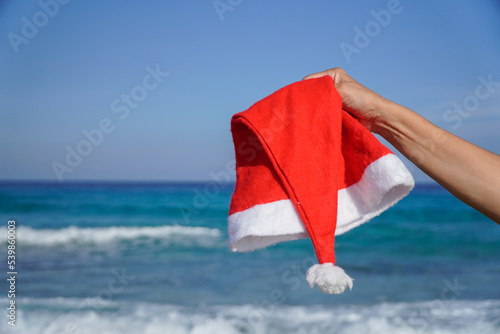 Christmas hat in the beach. Santa hat in Christmas holiday