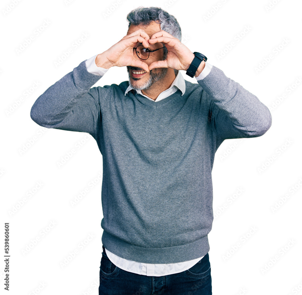 Middle age hispanic with grey hair wearing glasses doing heart shape with hand and fingers smiling looking through sign Middle age hispanic with grey hair wearing glasses doing heart shape with hand and fingers smiling looking through sign