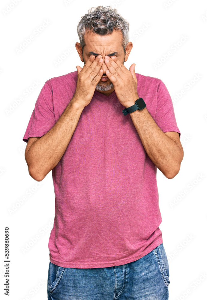 Middle age grey-haired man wearing casual clothes rubbing eyes for fatigue and headache, sleepy and tired expression. vision problem Middle age grey-haired man wearing casual clothes rubbing eyes for fatigue and headache, sleepy and tired expression. vision problem