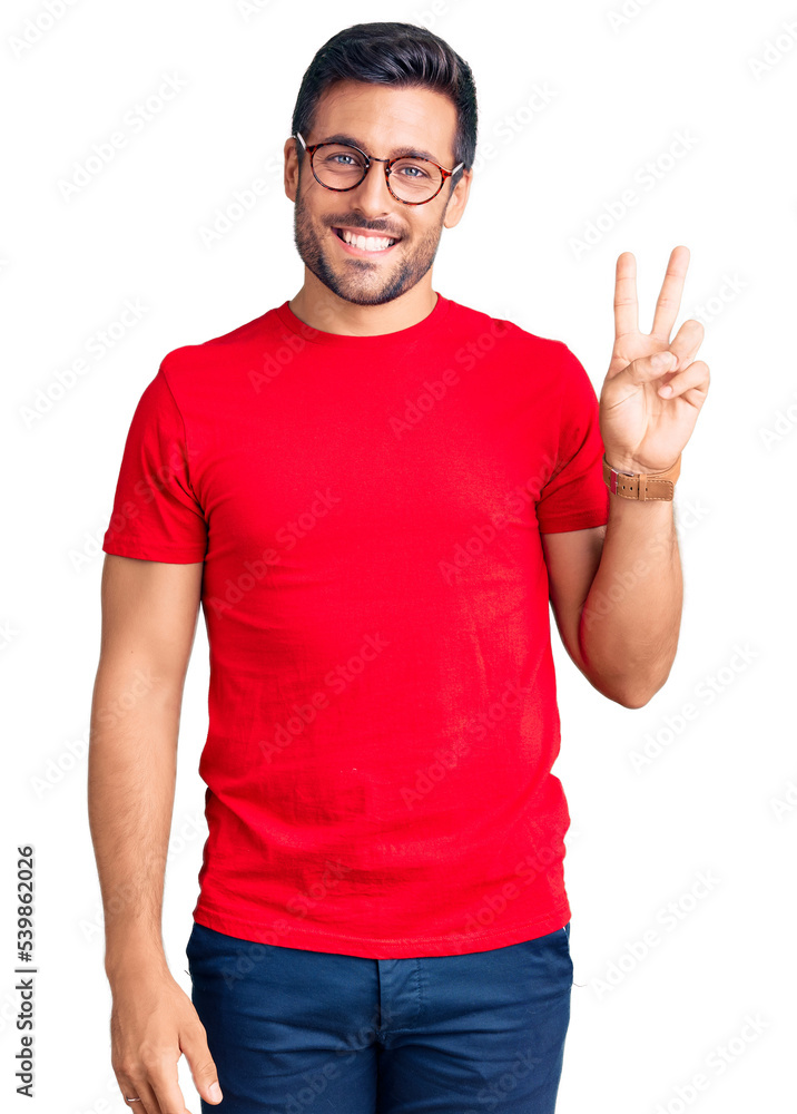 Young hispanic man wearing casual clothes and glasses smiling with happy face winking at the camera doing victory sign. number two. Young hispanic man wearing casual clothes and glasses smiling with happy face winking at the camera doing victory sign. number two.
