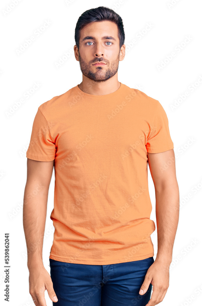 Fototapeta premium Young hispanic man wearing casual clothes with serious expression on face. simple and natural looking at the camera.