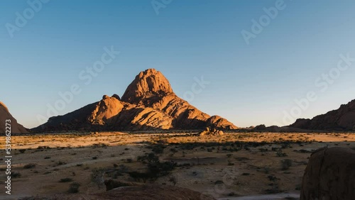 Time lapse view of sunrise over Spitzkoppe mountain in the Namib Desert of Namibia, Africa. photo