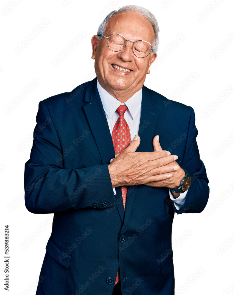 Senior man with grey hair wearing business suit and glasses smiling with hands on chest with closed eyes and grateful gesture on face. health concept. Senior man with grey hair wearing business suit and glasses smiling with hands on chest with closed eyes and grateful gesture on face. health concept.