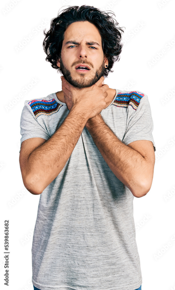 Young hispanic man wearing casual t shirt shouting and suffocate because painful strangle. health problem. asphyxiate and suicide concept. Young hispanic man wearing casual t shirt shouting and suffocate because painful strangle. health problem. asphyxiate and suicide concept.