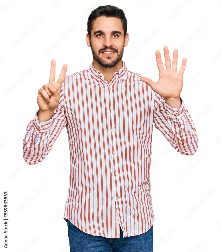 Young hispanic man wearing business shirt showing and pointing up with fingers number seven while smiling confident and happy. Young hispanic man wearing business shirt showing and pointing up with fingers number seven while smiling confident and happy.