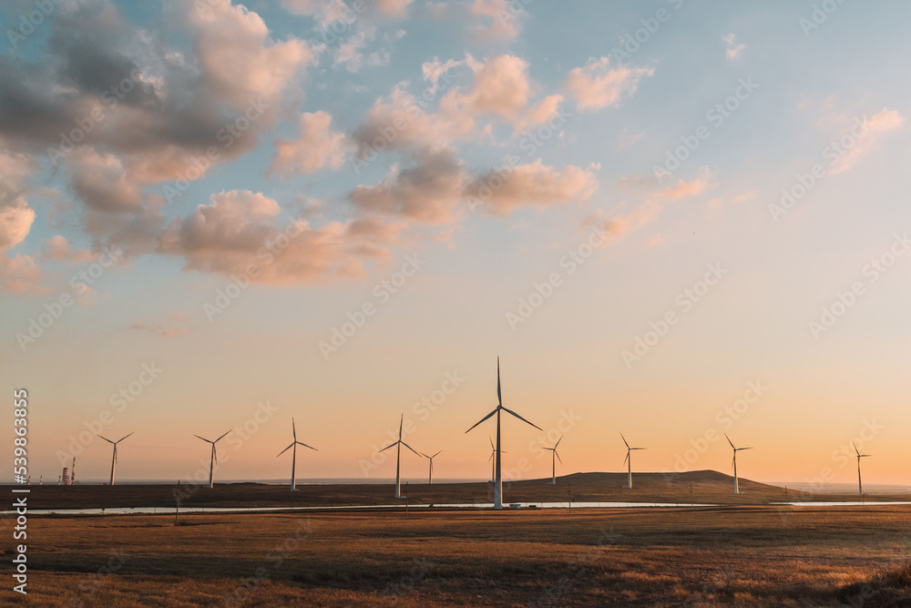 Obraz premium wind turbine at sunset