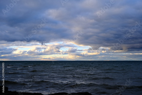 Wind and clouds sweep over the lake on an autumn evening