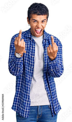 Young african amercian man wearing casual clothes showing middle finger doing fuck you bad expression, provocation and rude attitude. screaming excited