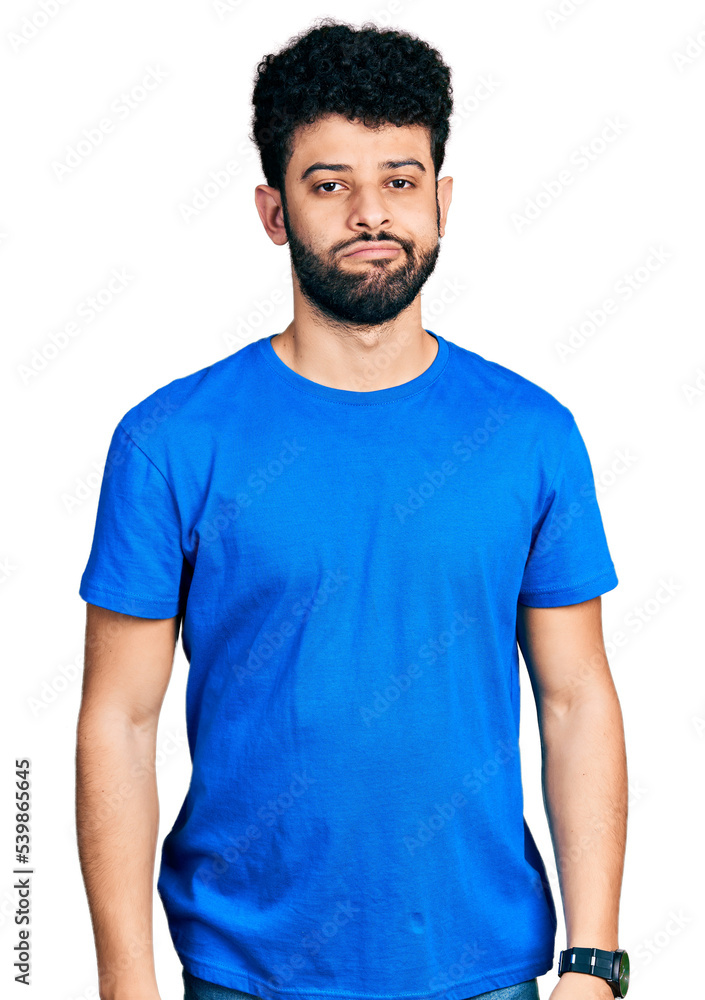 Fototapeta premium Young arab man with beard wearing casual blue t shirt looking sleepy and tired, exhausted for fatigue and hangover, lazy eyes in the morning.