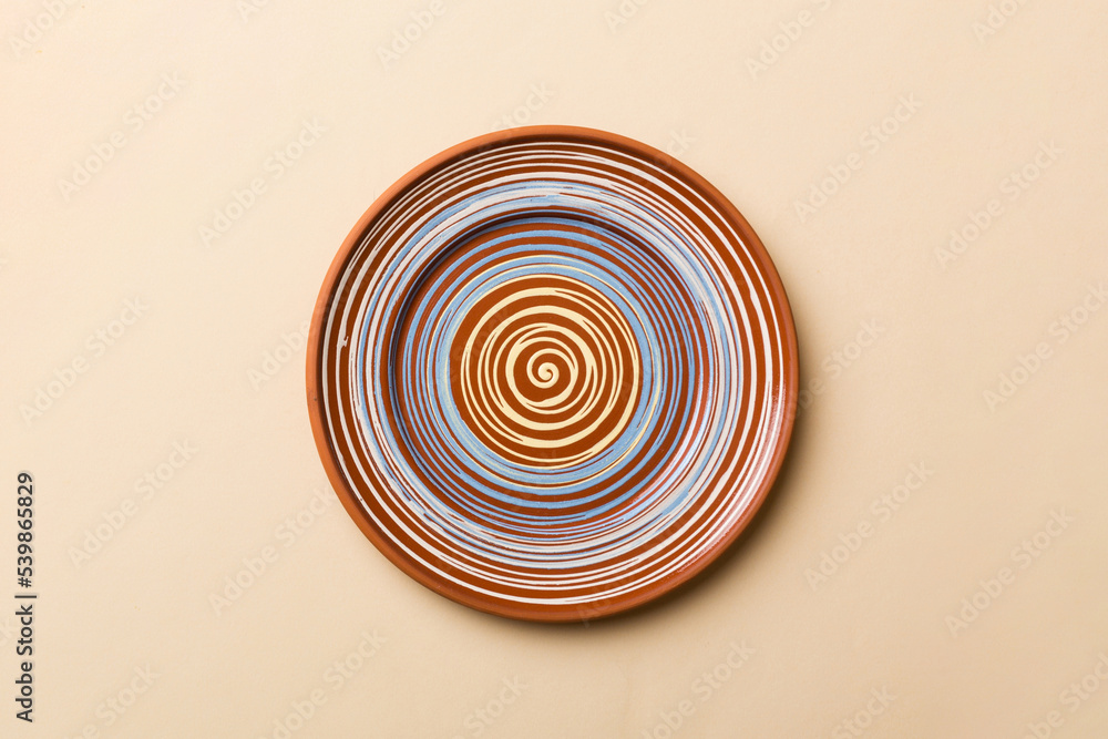 Top view of isolated of colored background empty round brown plate for food. Empty dish with space for your design Top view of isolated of colored background empty round brown plate for food. Empty dish with space for your design