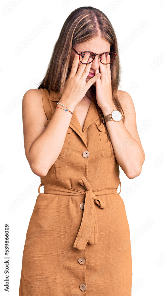 Young beautiful blonde woman wearing casual clothes and glasses with sad expression covering face with hands while crying. depression concept. Young beautiful blonde woman wearing casual clothes and glasses with sad expression covering face with hands while crying. depression concept.