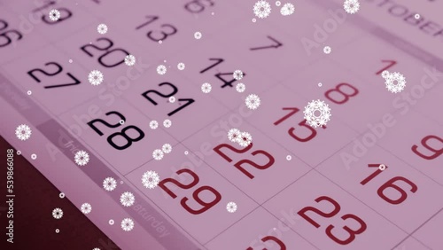 Calendar pages flipping mixed with falling snowflakes. Time is running, year passing by, new days come. Winter holidays concept photo