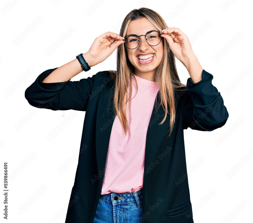 Hispanic young woman wearing elegant jacket and glasses smiling with a happy and cool smile on face. showing teeth. Hispanic young woman wearing elegant jacket and glasses smiling with a happy and cool smile on face. showing teeth.