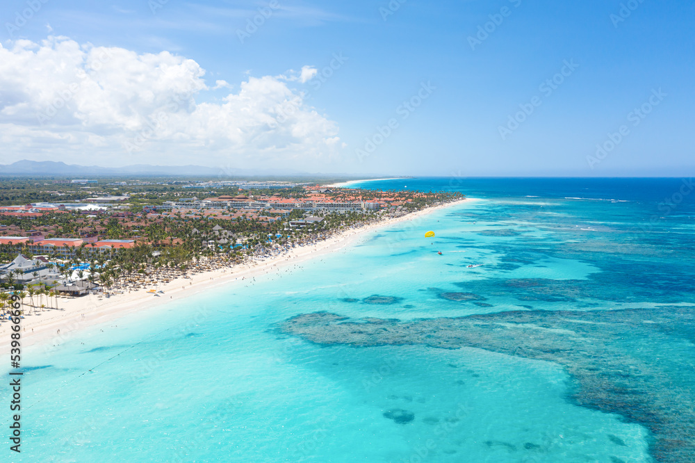 Bounty and pristine sandy shore with coconut palm trees, caribbean sea washes tropical coast. Arenda Gorda beach. Dominican Republic. Aerial view