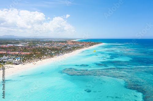 Bounty and pristine sandy shore with coconut palm trees, caribbean sea washes tropical coast. Arenda Gorda beach. Dominican Republic. Aerial view