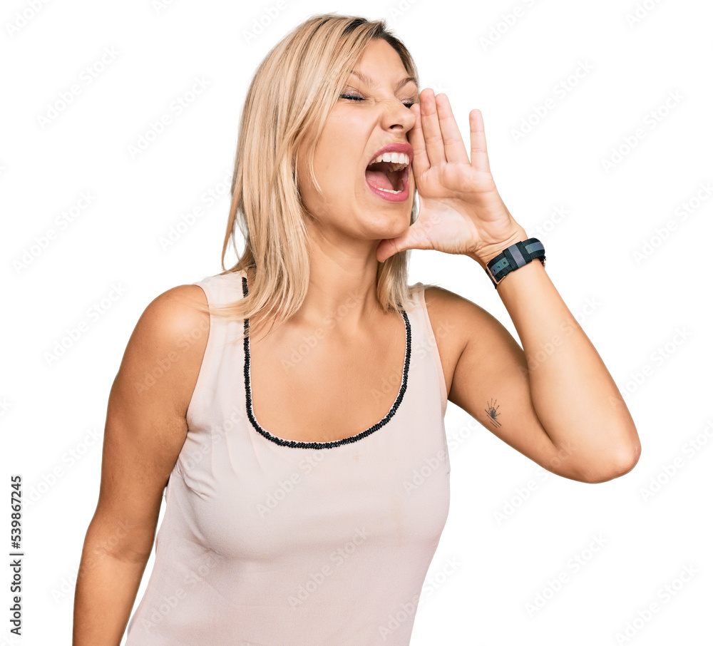 Middle age caucasian woman wearing casual clothes shouting and screaming loud to side with hand on mouth. communication concept. Middle age caucasian woman wearing casual clothes shouting and screaming loud to side with hand on mouth. communication concept.