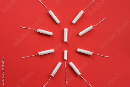 There are tampons on a red background. Women Health. Soft focus © VK