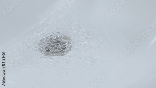 the bathroom sink draining slowly. clogged bathroom sink is a common problem, need to call a plumber. Close up slow motion