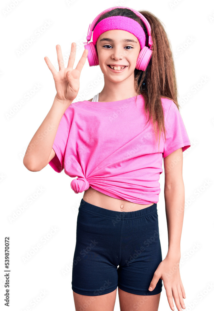 Cute hispanic child girl wearing gym clothes and using headphones showing and pointing up with fingers number four while smiling confident and happy. Cute hispanic child girl wearing gym clothes and using headphones showing and pointing up with fingers number four while smiling confident and happy.
