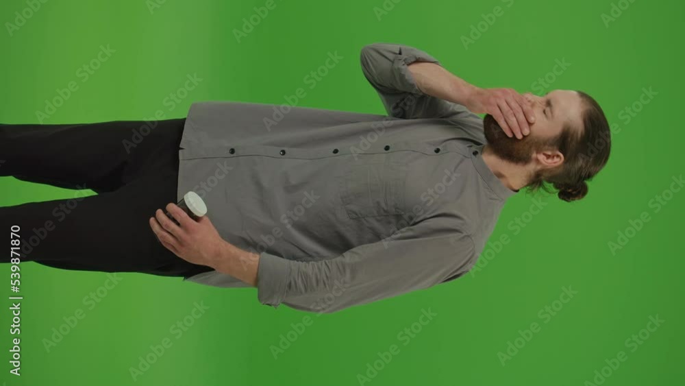 Vertical Video.Portrait of a Distressed Young Bearded Man with a Cough