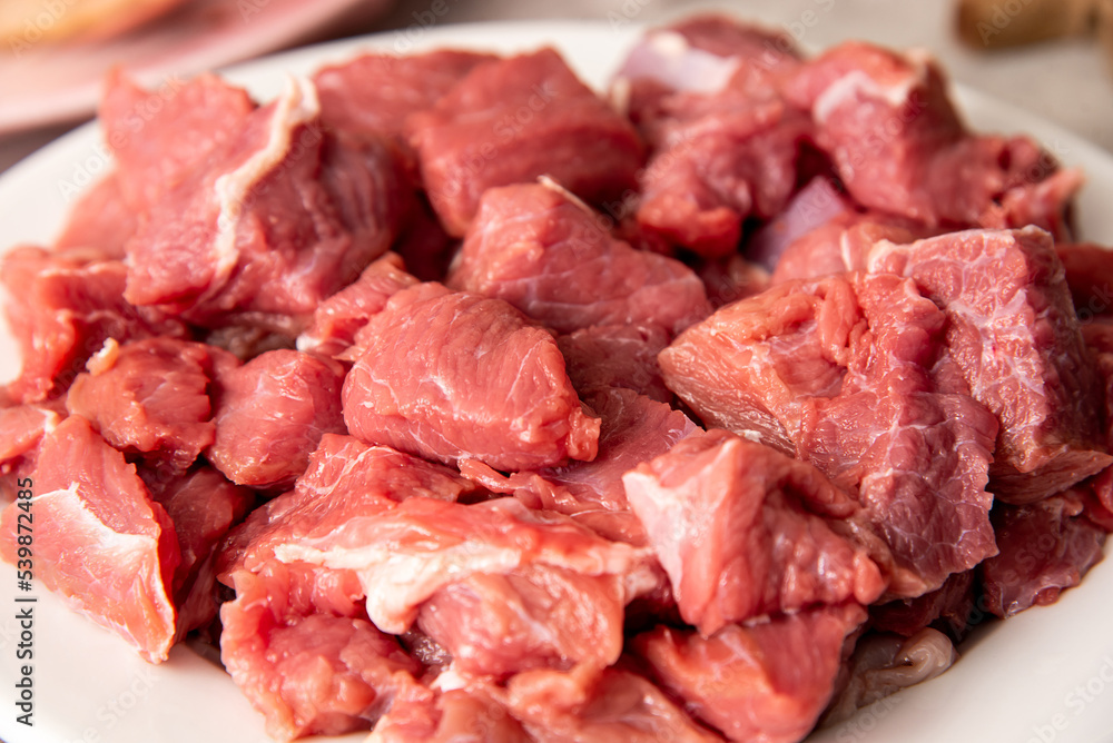fresh raw sliced meat on a white plate fresh raw sliced meat on a white plate