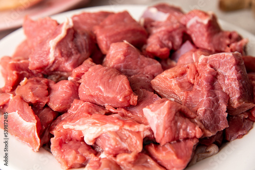 fresh raw sliced meat on a white plate