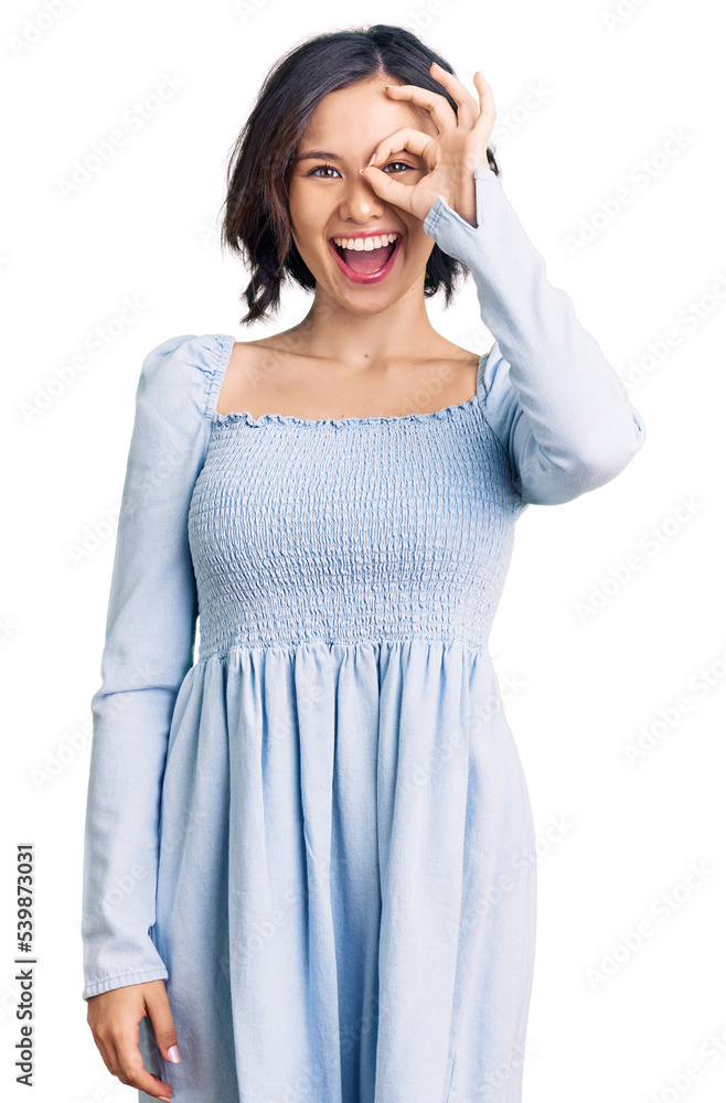 Young beautiful girl wearing casual clothes doing ok gesture with hand smiling, eye looking through fingers with happy face. Young beautiful girl wearing casual clothes doing ok gesture with hand smiling, eye looking through fingers with happy face.