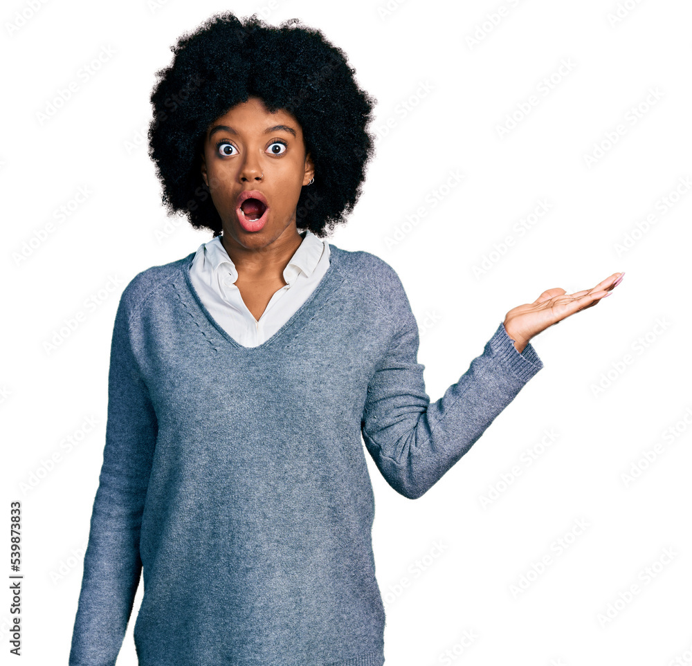 Young african american woman presenting with open palm afraid and shocked with surprise and amazed expression, fear and excited face. Young african american woman presenting with open palm afraid and shocked with surprise and amazed expression, fear and excited face.