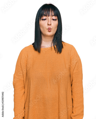 Young hispanic woman wearing casual clothes making fish face with lips, crazy and comical gesture. funny expression.