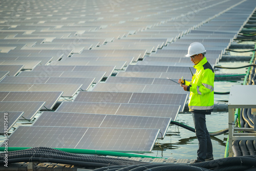 Wallpaper Mural Portrait of professional man engineer working checking the panels at solar energy on buoy floating. Power plant with water, renewable energy source. Eco technology for electric power in industry. Torontodigital.ca