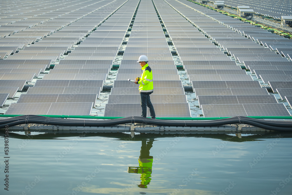 custom made wallpaper toronto digitalPortrait of professional man engineer working checking the panels at solar energy on buoy floating. Power plant with water, renewable energy source. Eco technology for electric power in industry.