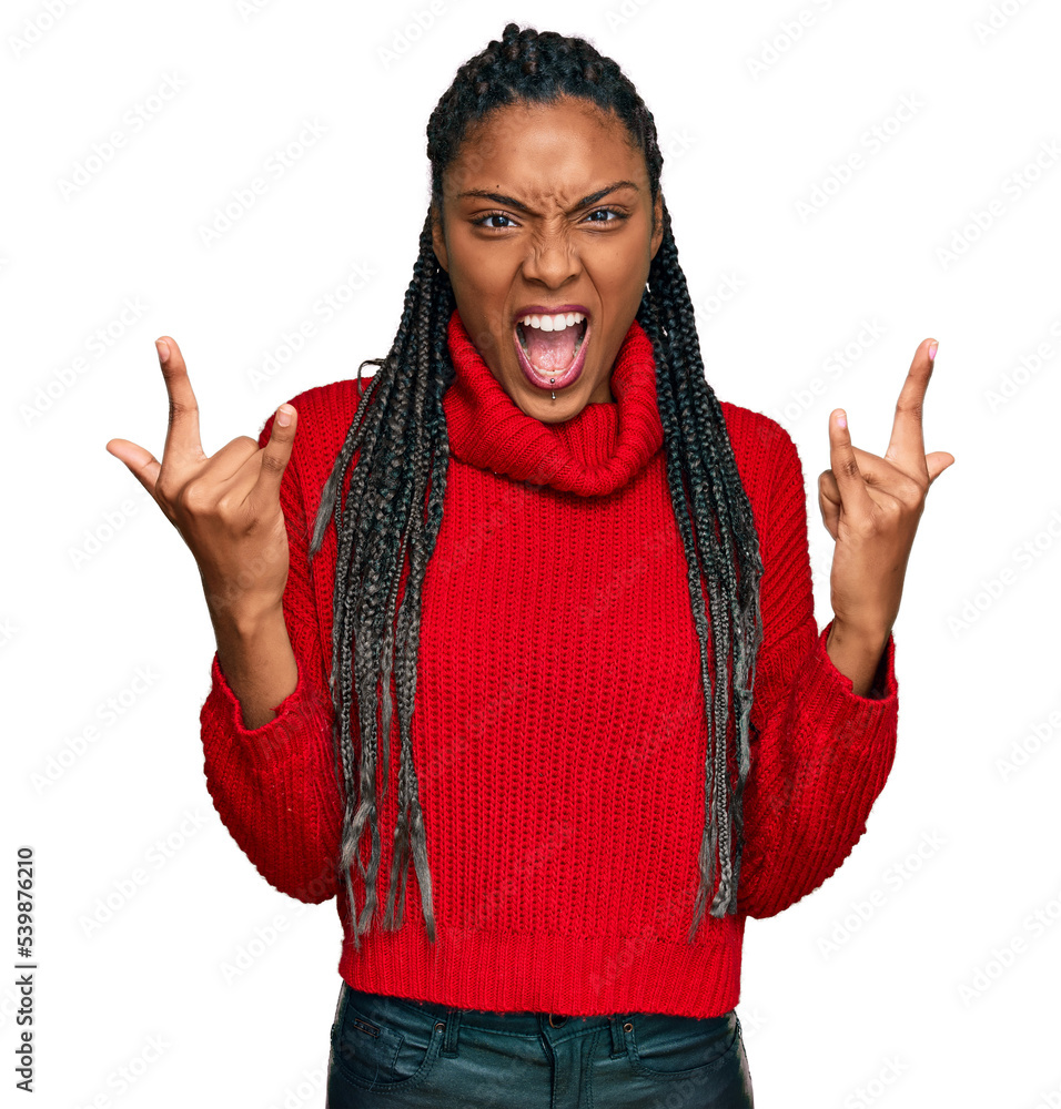 African american woman wearing casual winter sweater shouting with crazy expression doing rock symbol with hands up. music star. heavy concept. African american woman wearing casual winter sweater shouting with crazy expression doing rock symbol with hands up. music star. heavy concept.