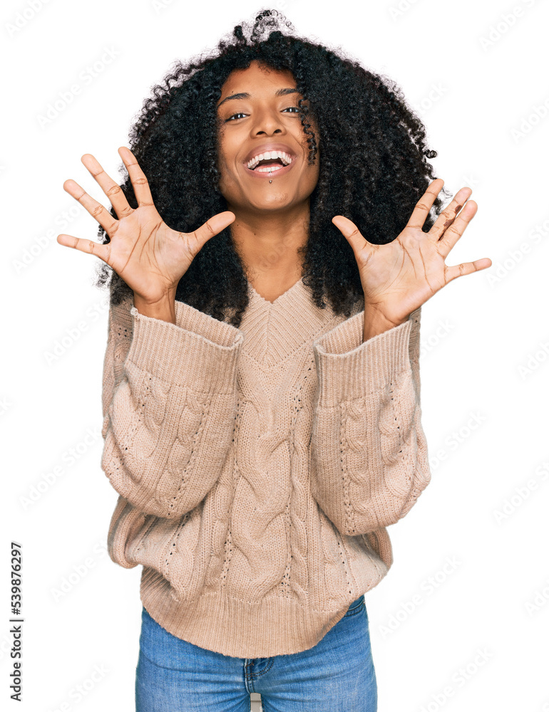 Young african american girl wearing casual clothes showing and pointing up with fingers number ten while smiling confident and happy. Young african american girl wearing casual clothes showing and pointing up with fingers number ten while smiling confident and happy.