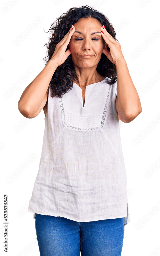 Middle age beautiful woman wearing casual sleeveless t shirt suffering from headache desperate and stressed because pain and migraine. hands on head. Middle age beautiful woman wearing casual sleeveless t shirt suffering from headache desperate and stressed because pain and migraine. hands on head.