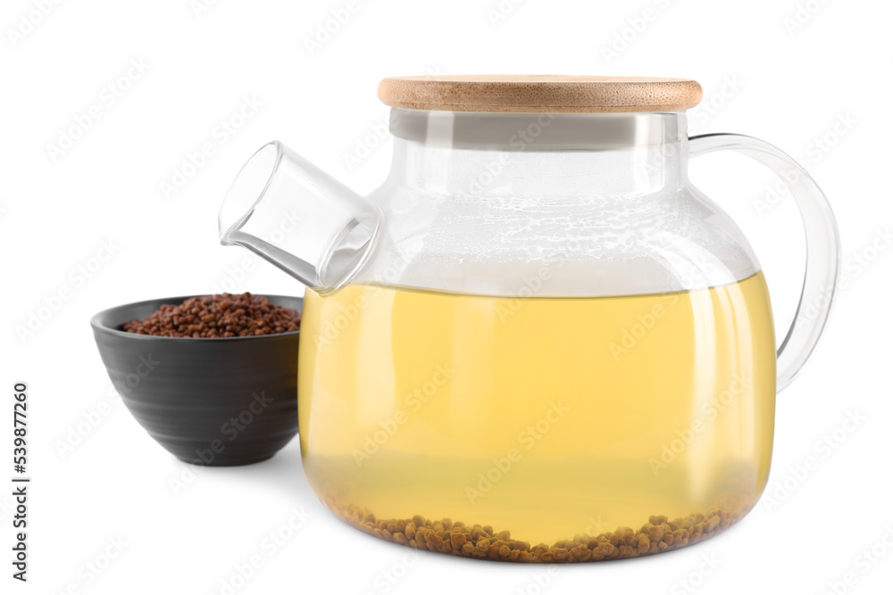 Glass teapot with aromatic buckwheat tea and granules on white background Glass teapot with aromatic buckwheat tea and granules on white background