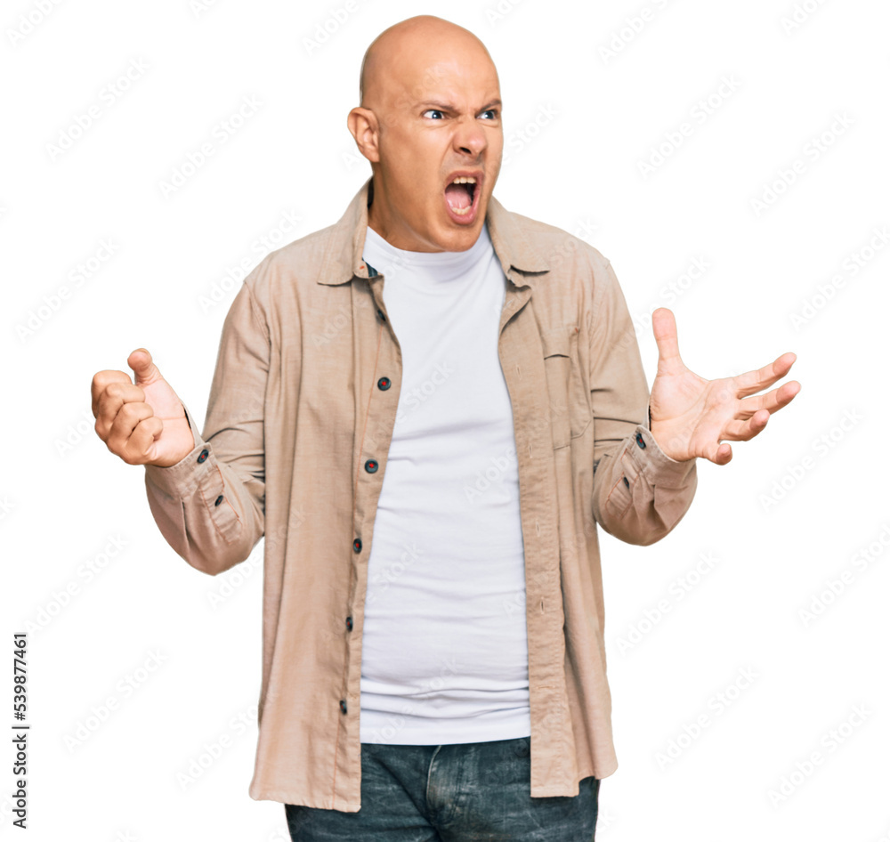 Middle age bald man wearing casual clothes crazy and mad shouting and yelling with aggressive expression and arms raised. frustration concept.