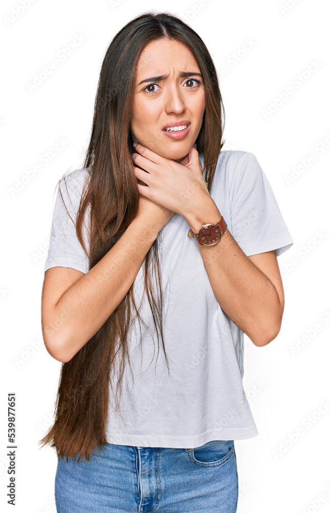 Young hispanic girl wearing casual white t shirt shouting suffocate because painful strangle. health problem. asphyxiate and suicide concept. Young hispanic girl wearing casual white t shirt shouting suffocate because painful strangle. health problem. asphyxiate and suicide concept.