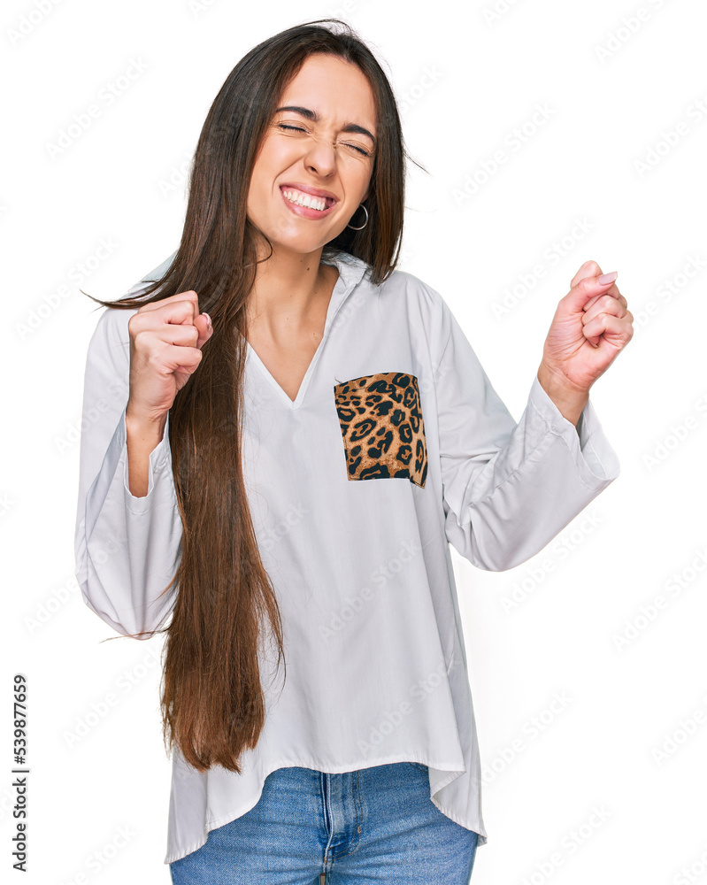 Obraz premium Young hispanic girl wearing casual clothes excited for success with arms raised and eyes closed celebrating victory smiling. winner concept.